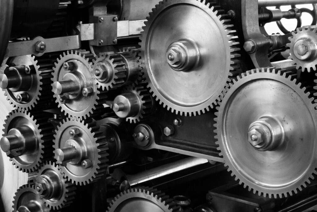 Cog wheels in a machinery demonstrating the critical processes and flows of an organisation. Essential for understanding business continuity. Designing the future of resilient organisations.